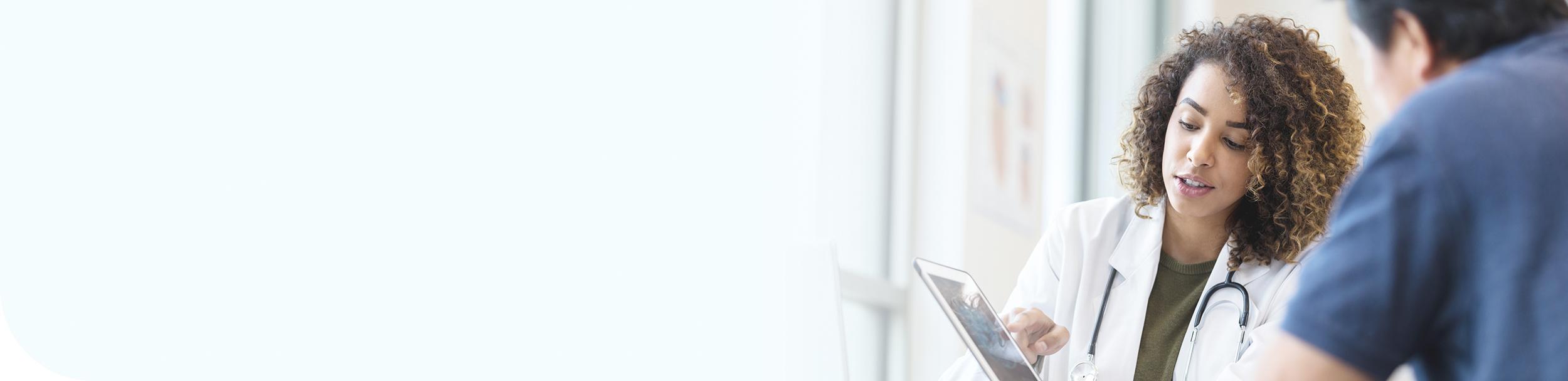 Doctor and patient reviewing XYWAV resources.