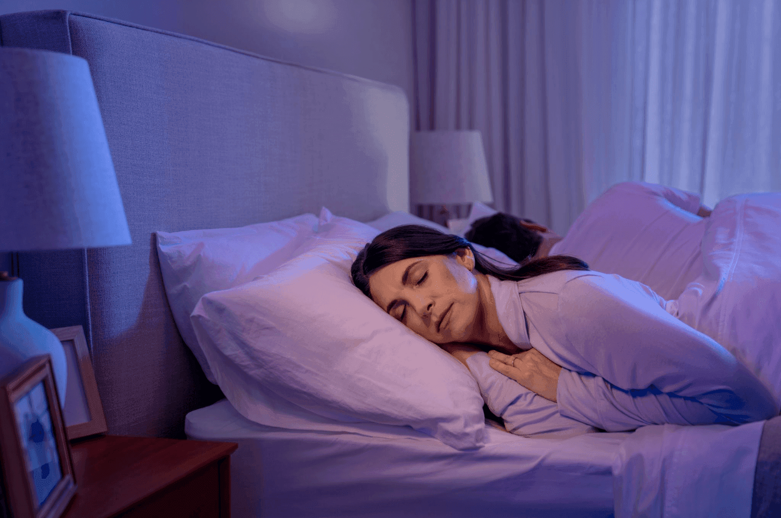 Woman sleeping peacefully in bed at night