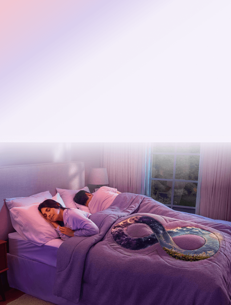 A couple sleeping peacefully in bed with an infinity symbol blanket